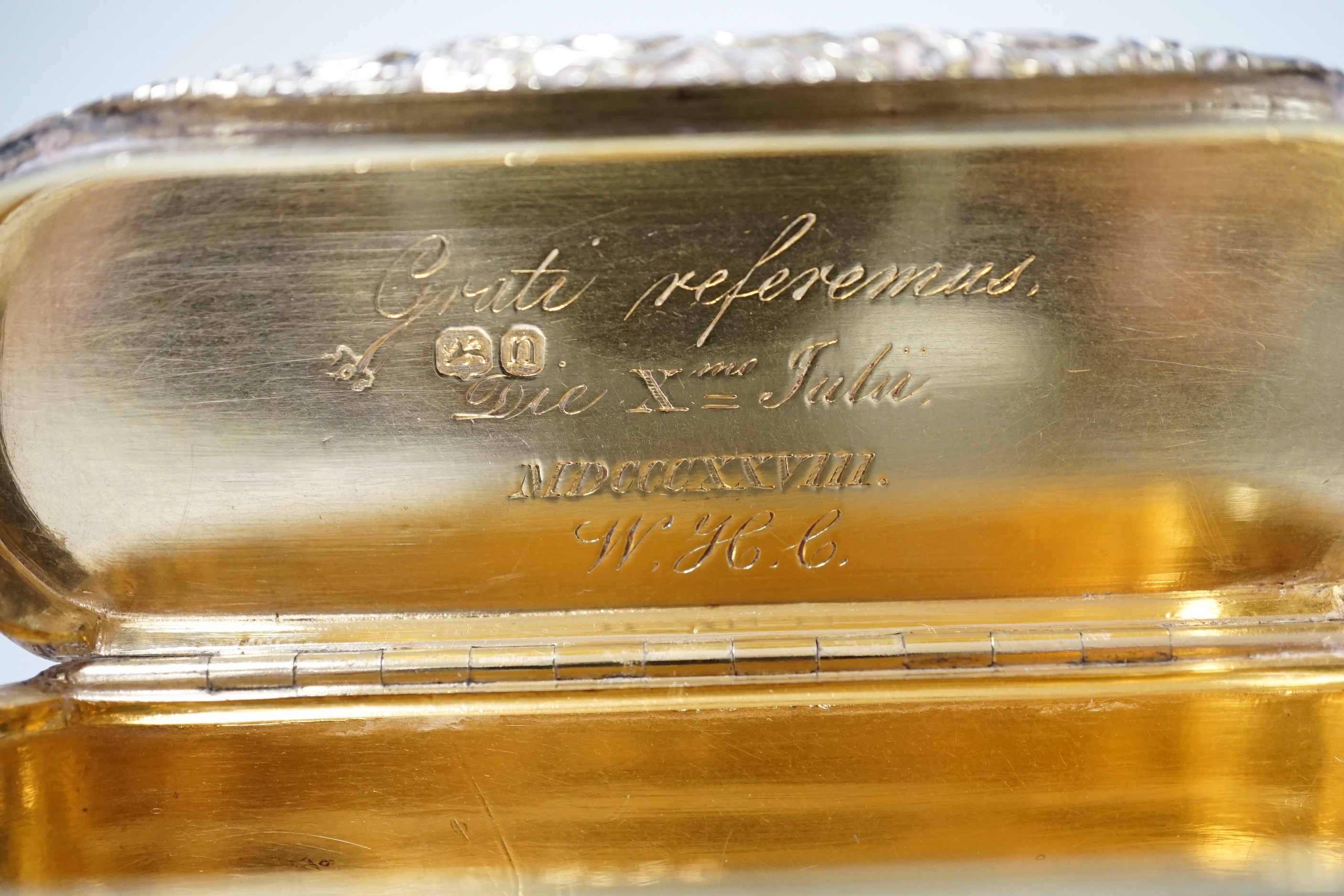 A George IV engine turned silver gilt oval snuff box, with interior Latin inscription, John Linnit, London, 1828, 9cm.